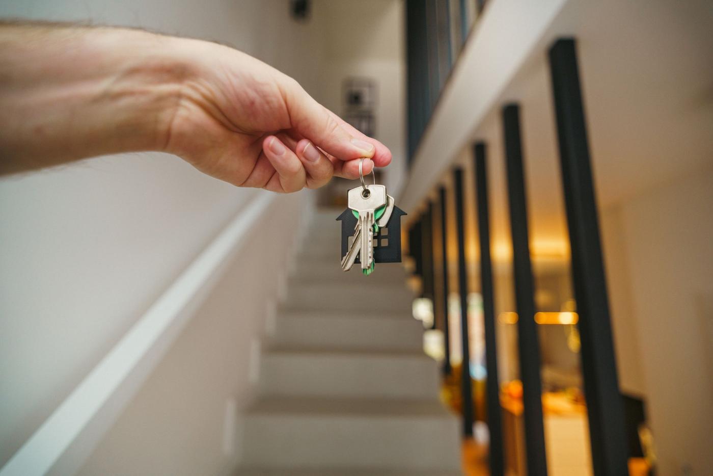 House keys being handed over on a staircase